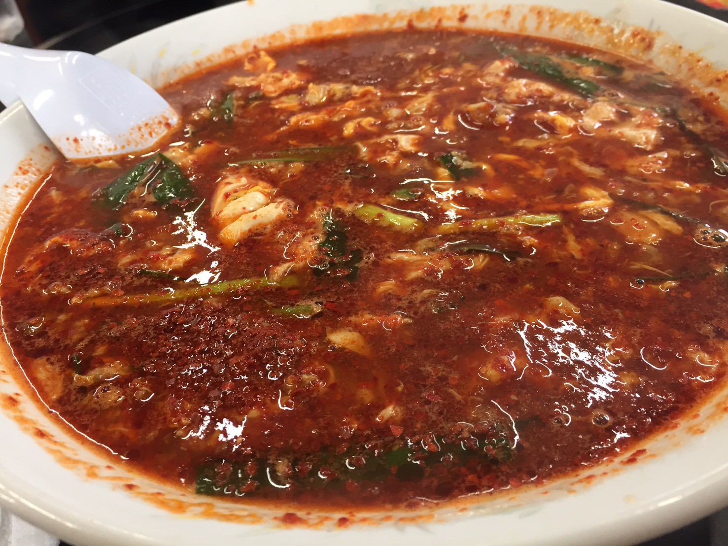 延岡発祥のソウルフード「辛麺屋 桝元」の辛麺（たっぷりのニラとニンニク、こんにゃく麺が入った赤いスープ）